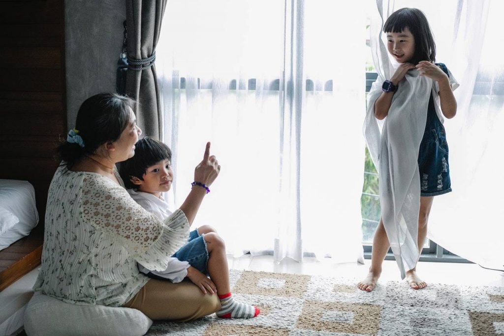 A babysitter taking care of two children - A babysitter taking care of two children
